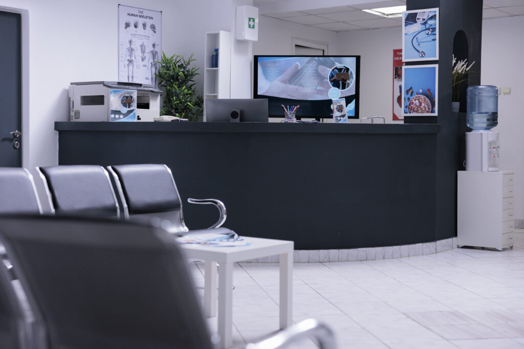 Nobody in hospital reception desk and waiting room at facility to attend medical consultation appointment. Waiting area lobby with chairs and counter at healthcare clinic, disease medicine.