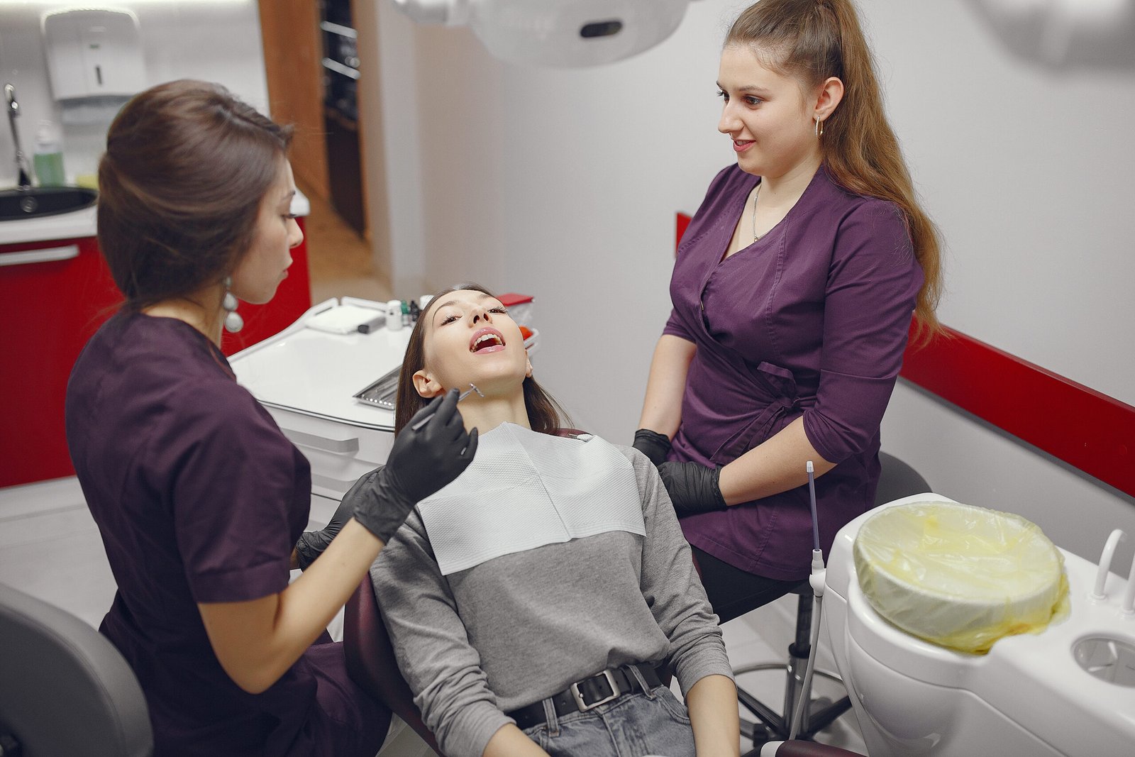 Beautiful lady in the dentist's office. Woman in a purple uniform