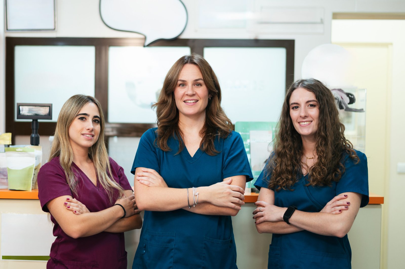 Female healthcare team standing with arms crossed in a modern veterinary clinic
